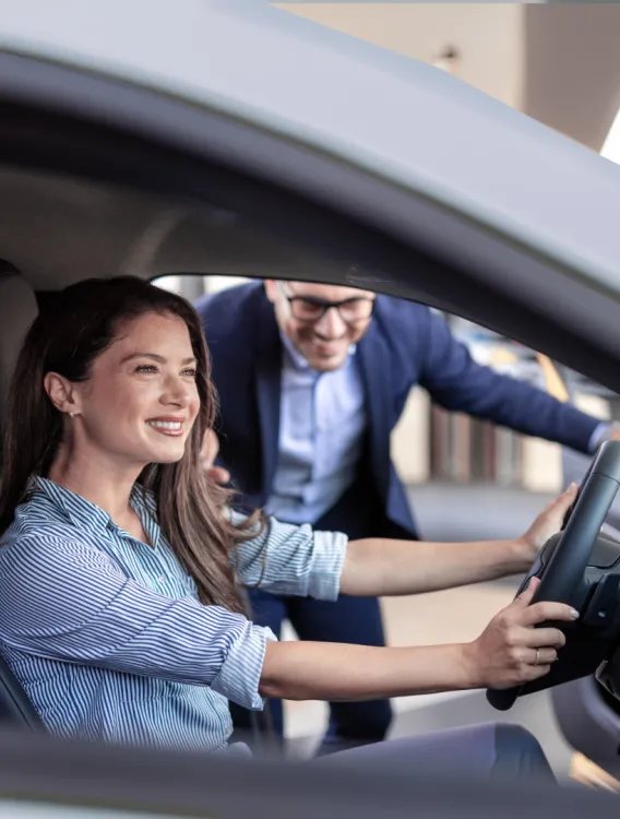 Woman receiving information about car before demo ride