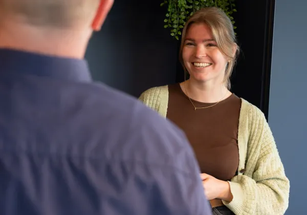 happy employee holding cup of coffee 